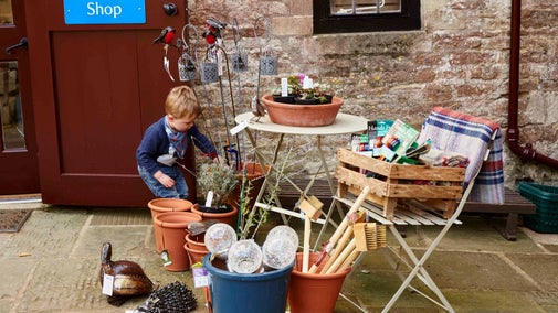 A boy outside the shop at Dyrham Park, Gloucestershire